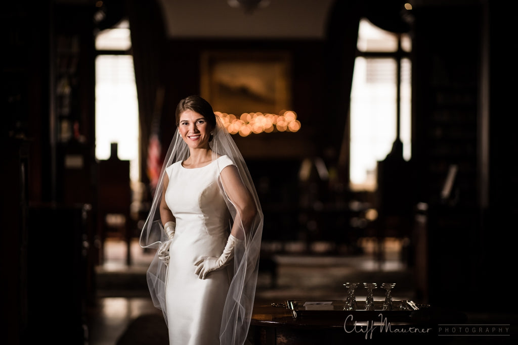 Cliff Mautner portrait of bride wearing wedding dress and veil gloves US flag American flag in background 