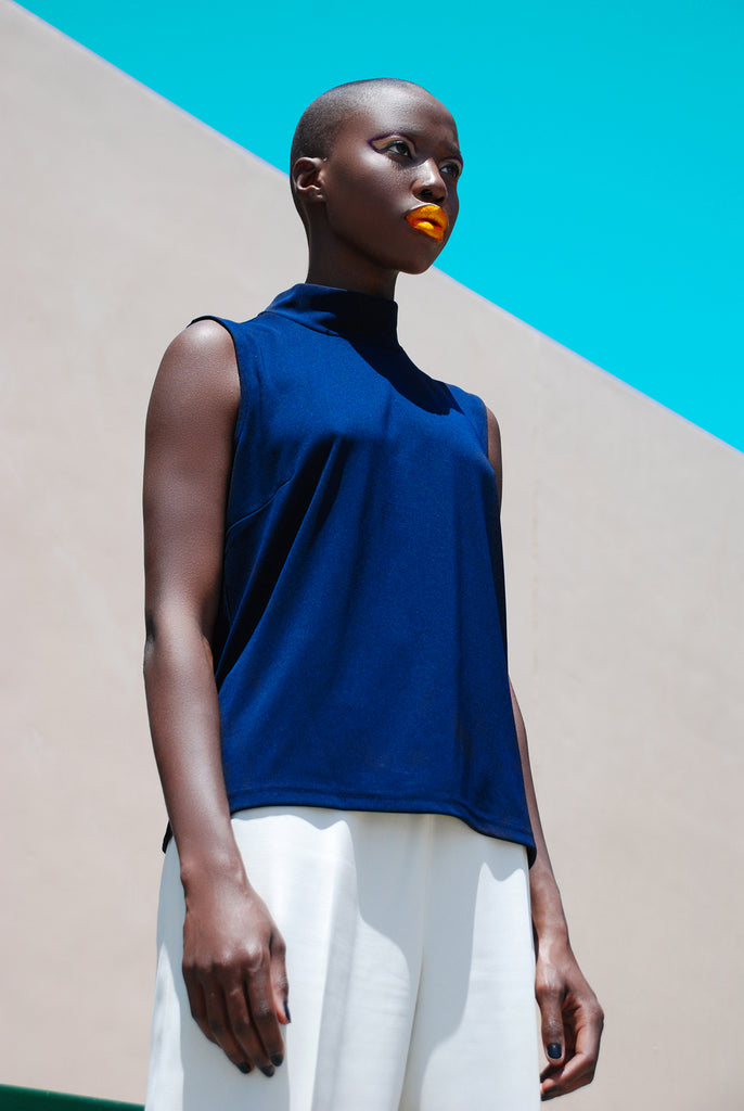 Irvin Rivera black woman wearing blue top and orange lipstick