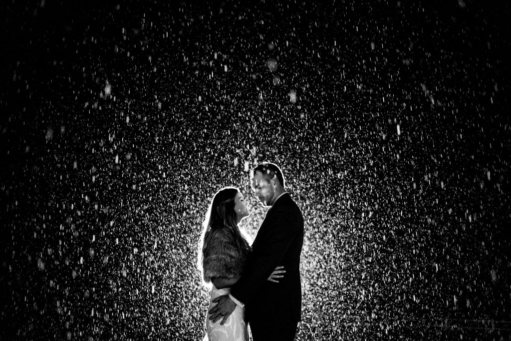 Jason Vinson bride and groom night bright light through raindrops
