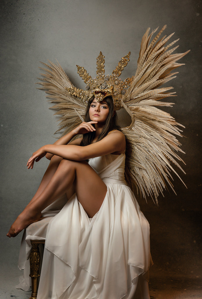 Ric_Lewis_woman in white dress with wings sitting on stool