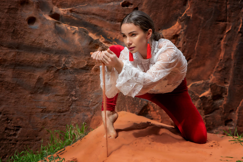Steve Batz woman holding sand in red rocks canyon red tassel earrings