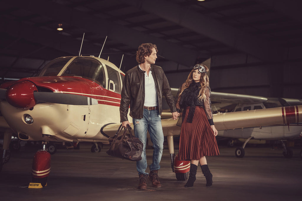 Yuliya Panchenko man and woman outside of airplane in hangar