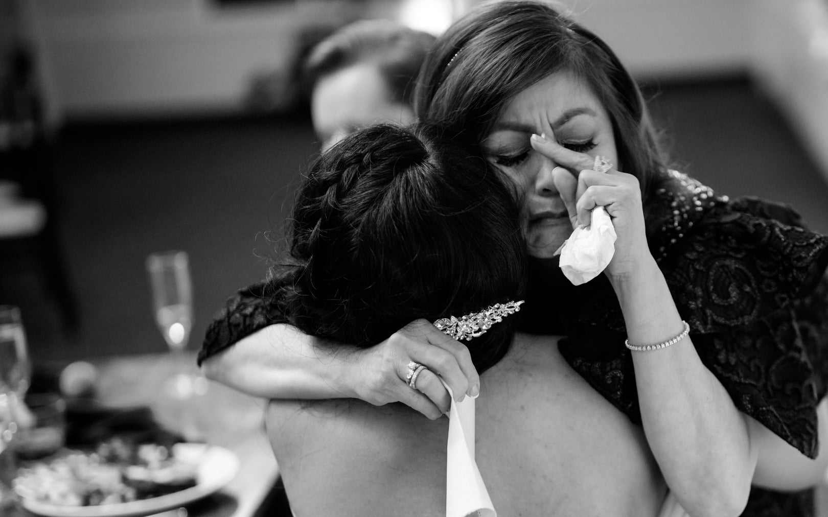 Mother of the bride crying and hugging bride