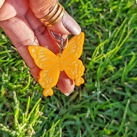 Pastel orange butterfly earrings. Engraved including hearts at the bottoms of the wings.