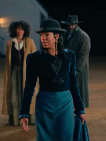 Treacherous Trudy, played by Regina King, in a blue velvet jacket and contrasting woven blue skirt.