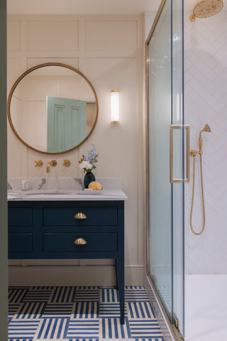 Pastel bathroom with brass taps and shower