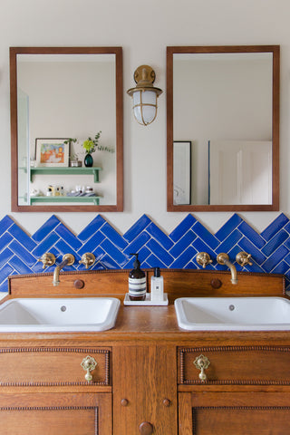 Brass taps in a wood timber and blue bathroom
