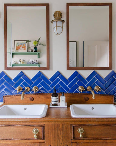 Electric blue and stained timber bathroom colour scheme with brass taps