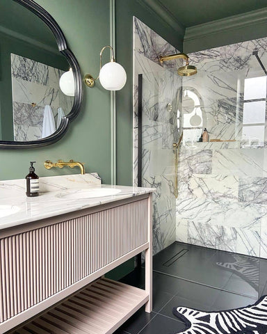 Green and pale pink bathroom colour scheme with brass