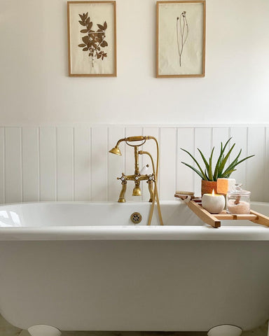 Neutral bathroom with roll top bath and unlaquered brass taps