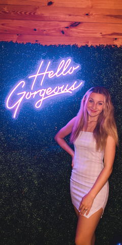 Hello Gorgeous purple neon sign at 16th birthday party