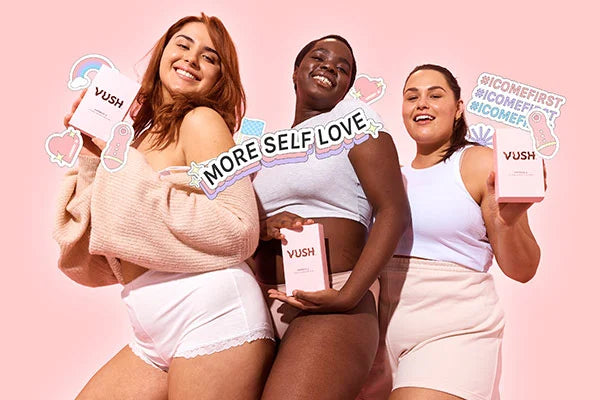 Three women holding VUSH vibrator boxes with stickers that read "more self love" and "I come first"