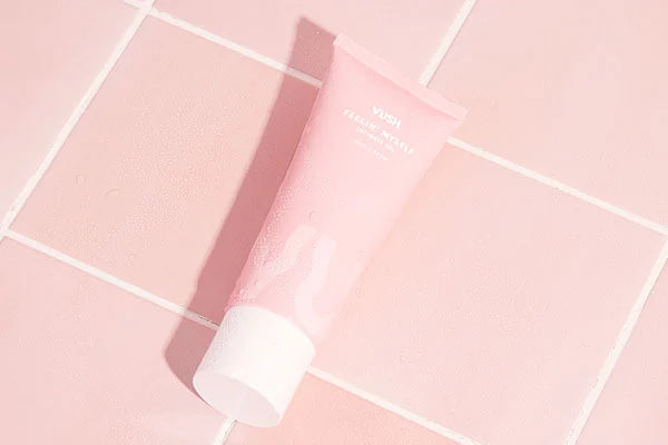 VUSH Intimate Gel in pink tube with white lid against pink tiles