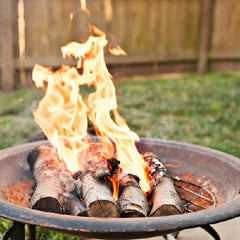 Fire wood burning in an outdoor garden fire pit 