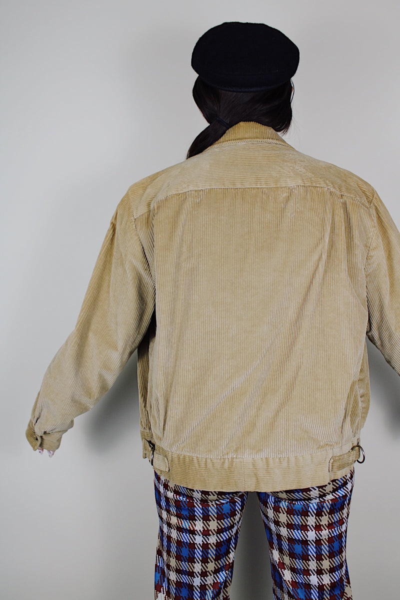 vintage 1980's long sleeve beige brown corduroy jacket with bronze zipper up the front, a pointy collar and side pockets