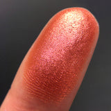 Close up shot of Amour eyeshadow swatched on a finger