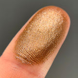 Close up shot of Caribou eyeshadow swatched on a finger