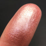 Close up shot of Pink Sugar eyeshadow swatched on a finger
