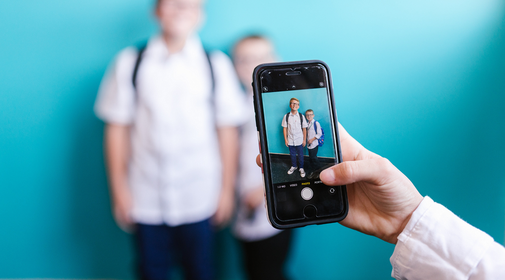 Students being taken a photo with mobile phones