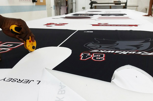 Picture-of-sublimation-print-being-cut-out.png__PID:89a75796-b8d6-4d57-86b1-74c9fde3b9d2
