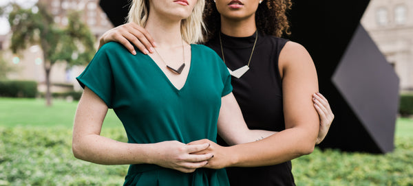 two women embracing wearing original quad necklaces by GRAMMAR