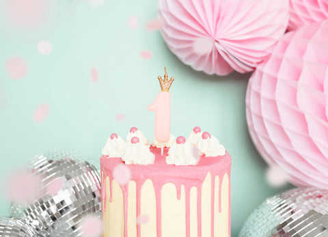 1st birthday pink candle on cake