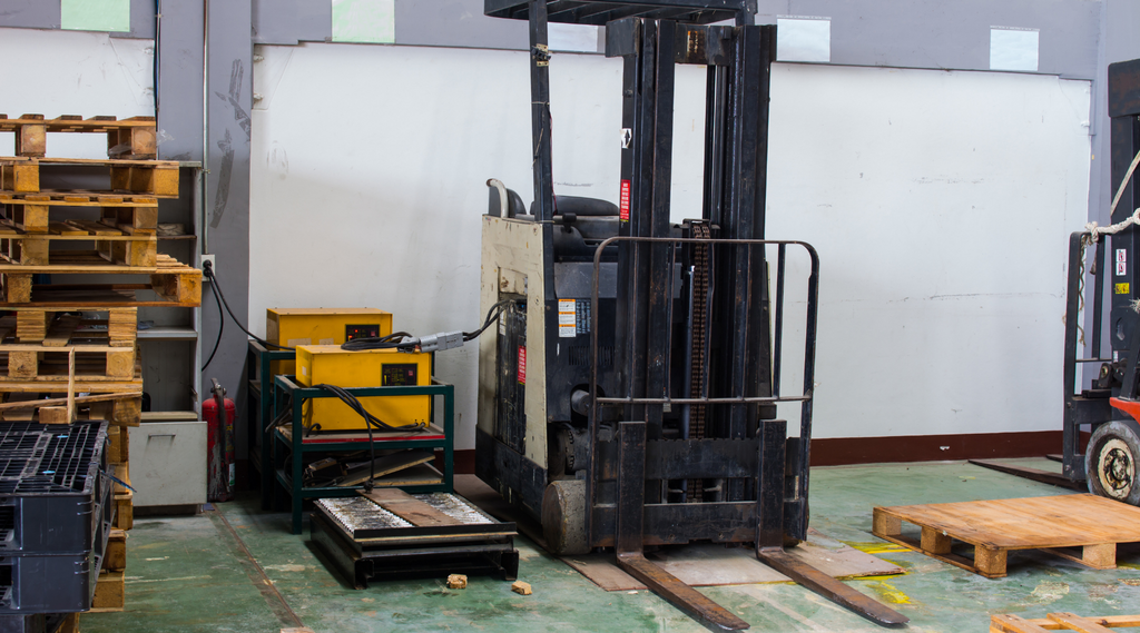 forklift truck plugged in a battery charging station