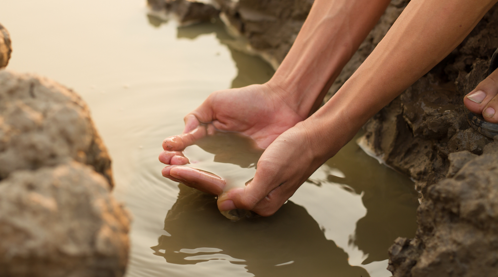 hands showing water pollution