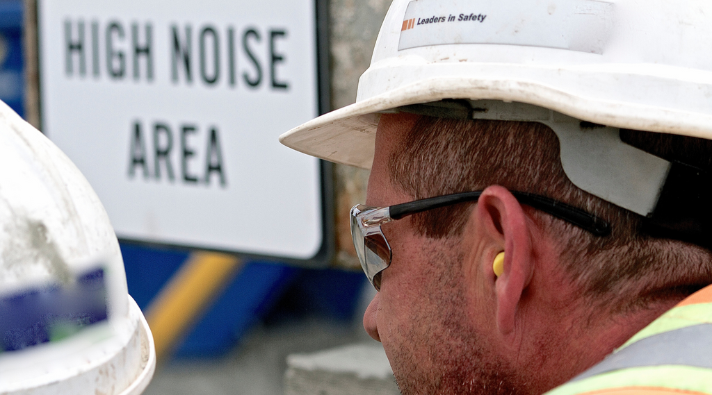 worker wearing earplugs for hearing protection