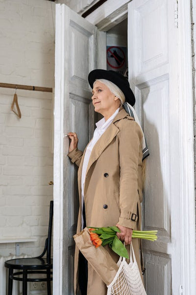 elderly woman coming home from shopping with a tote bag