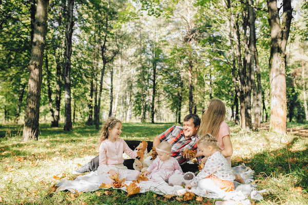 family having picnic in the woods