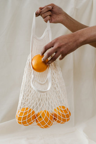 oranges in a reusable shopping bag