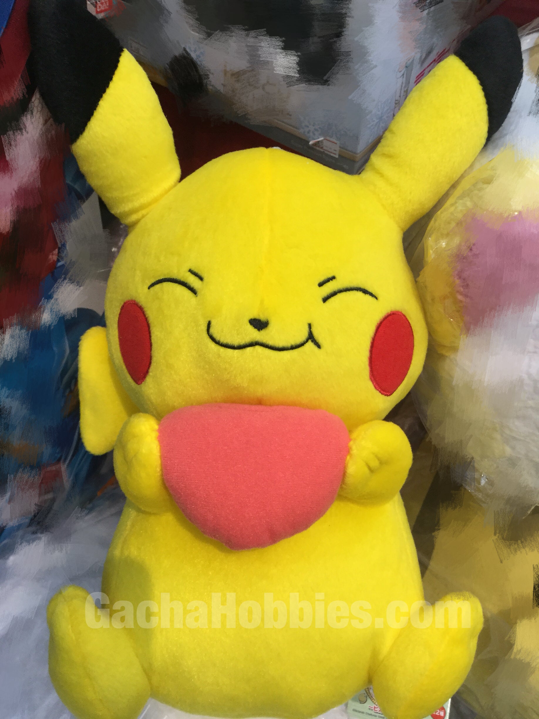 pikachu holding a heart plush