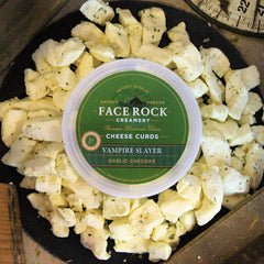 Package of Face Rock Vampire Slayer Curds surrounded by loose curds