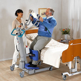 nurse assisting patient with a patient lift