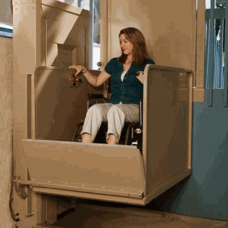 person in wheelchair using a wheelchair lift