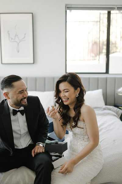 bride and groom wearing grillz and laughing