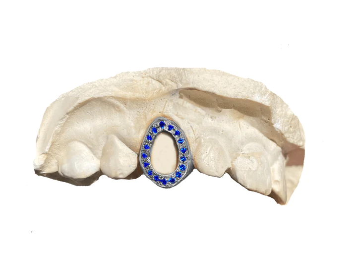 Open-faced single tooth sapphire grillz