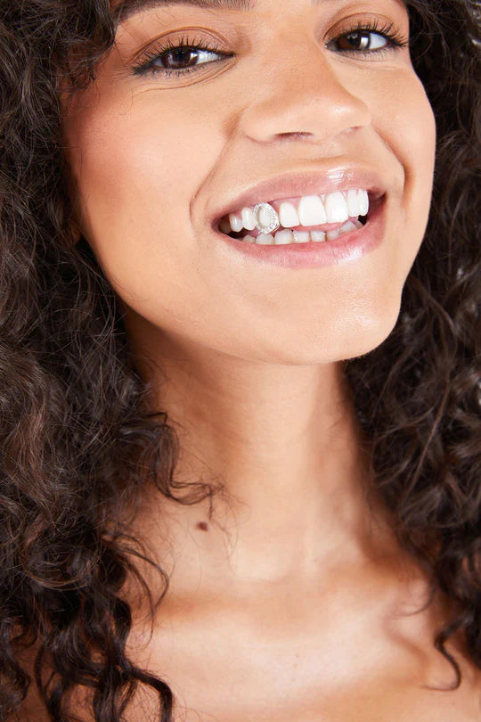 woman with single-tooth diamond grillz