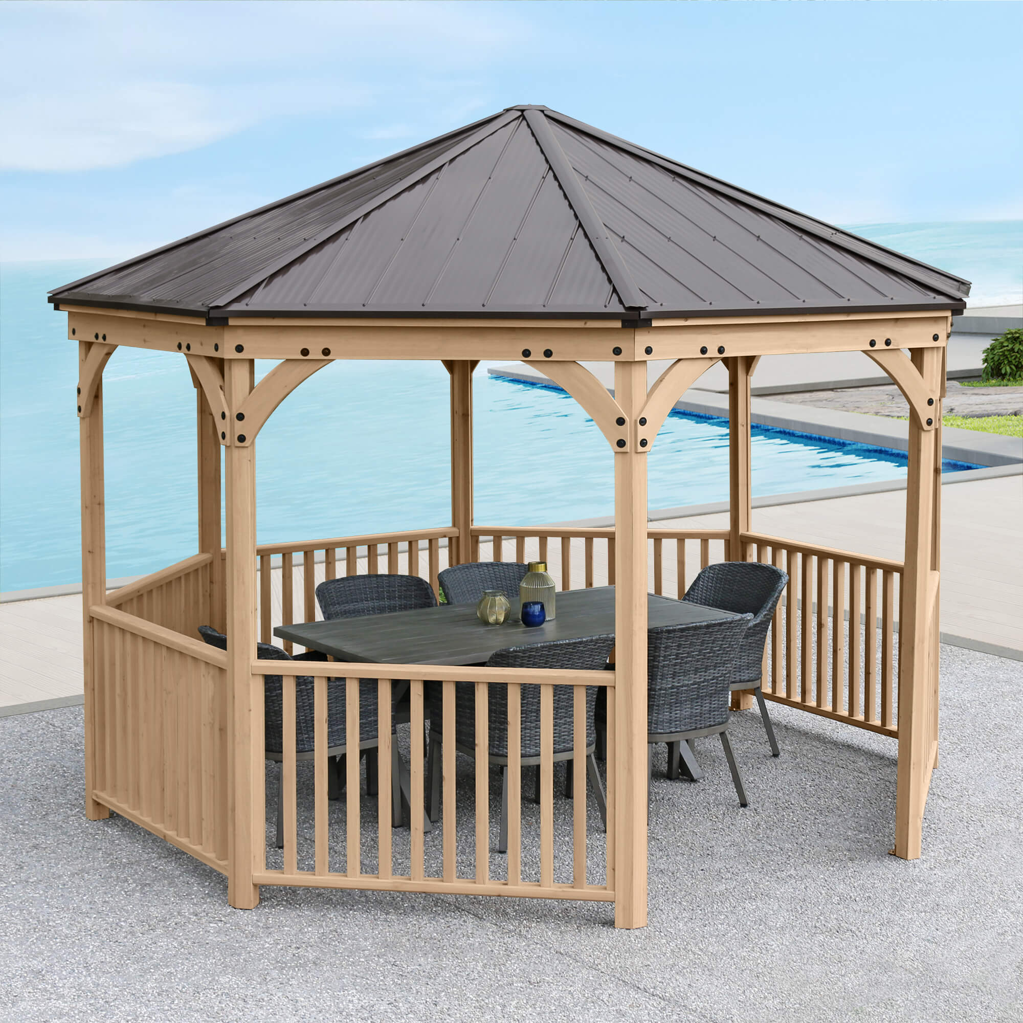 Yardistry Octagon 12ft Gazebo placed beside a pool with chairs & a table.