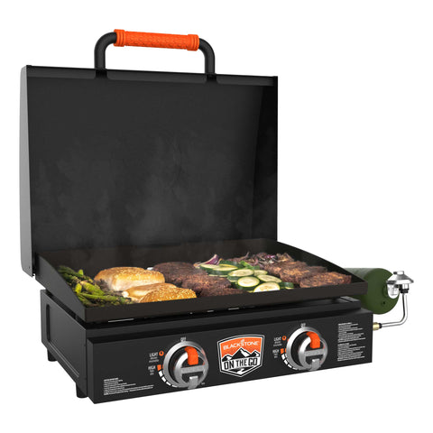 tabletop griddle with opened hood and grilled food