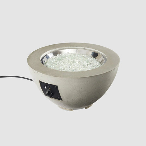 The Cove Round 29-inch gas fire pit bowl by Outdoor Greatroom Co, unlit, showcasing the stone finish and metal interior ring.