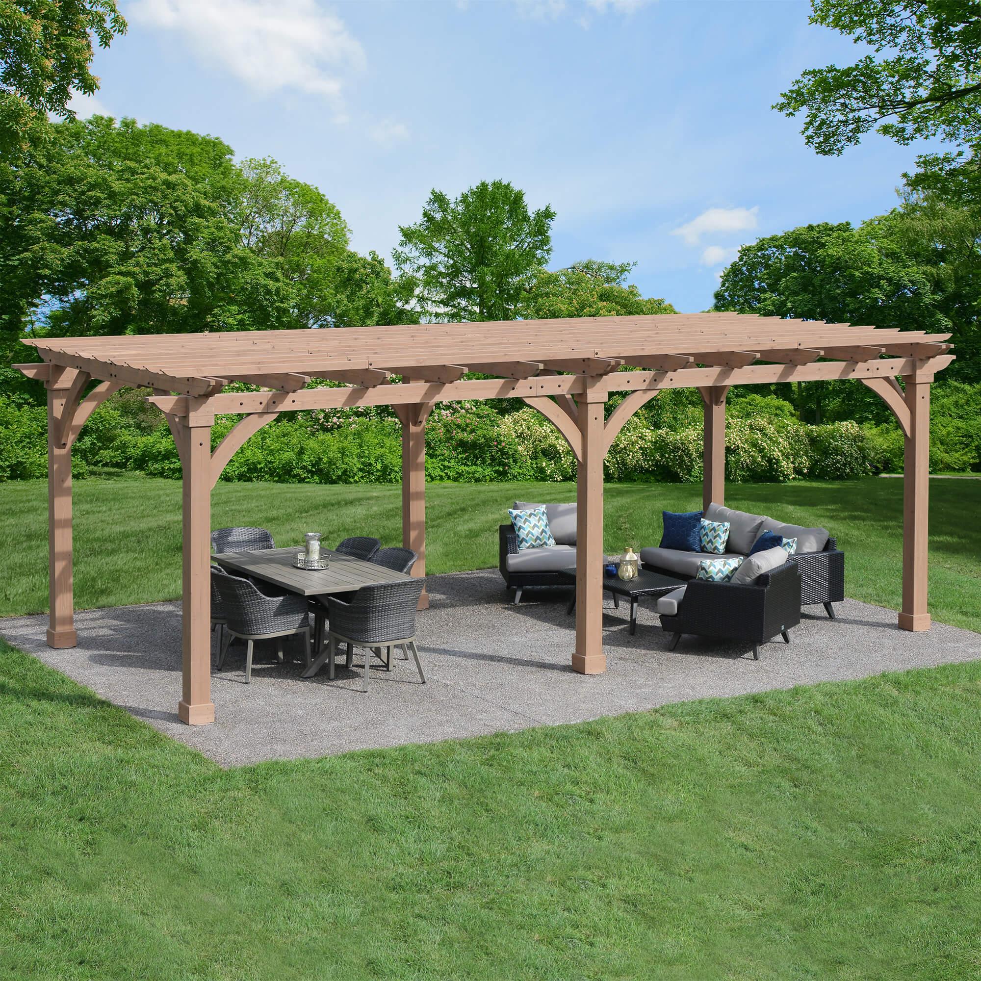 Complete YM12778 12x24 Pergola placed in an outdoor space with furniture.