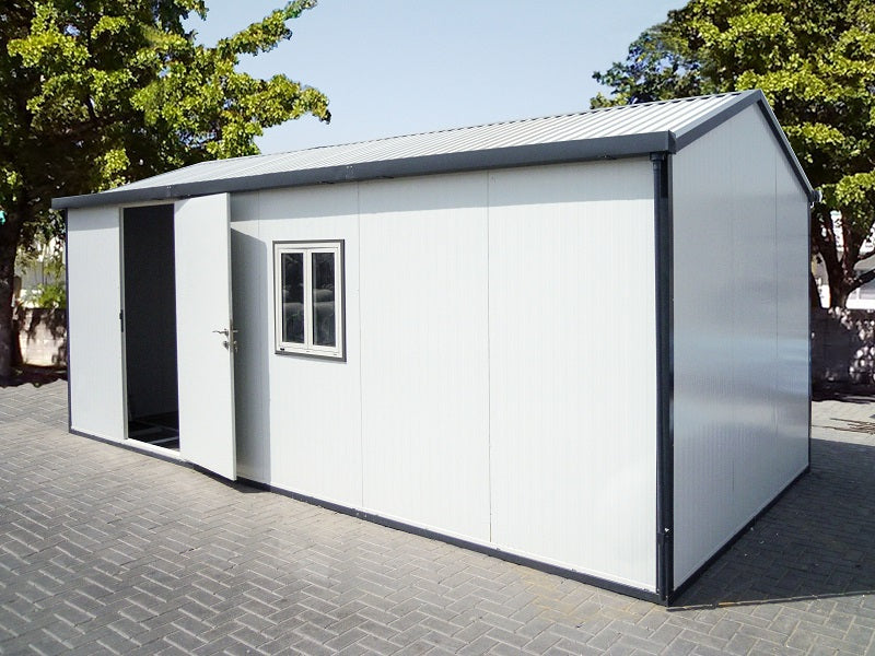 Duramax gable roof insulated building shown outdoors on a paved area, featuring wide doors and a window, ideal for various storage needs and environments.
