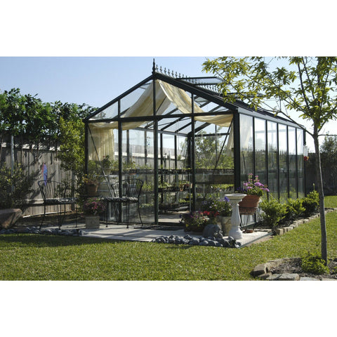Elegant design of an Exaco Janssens Victorian VI-34 greenhouse with spacious interior and garden tools visible through the glass.
