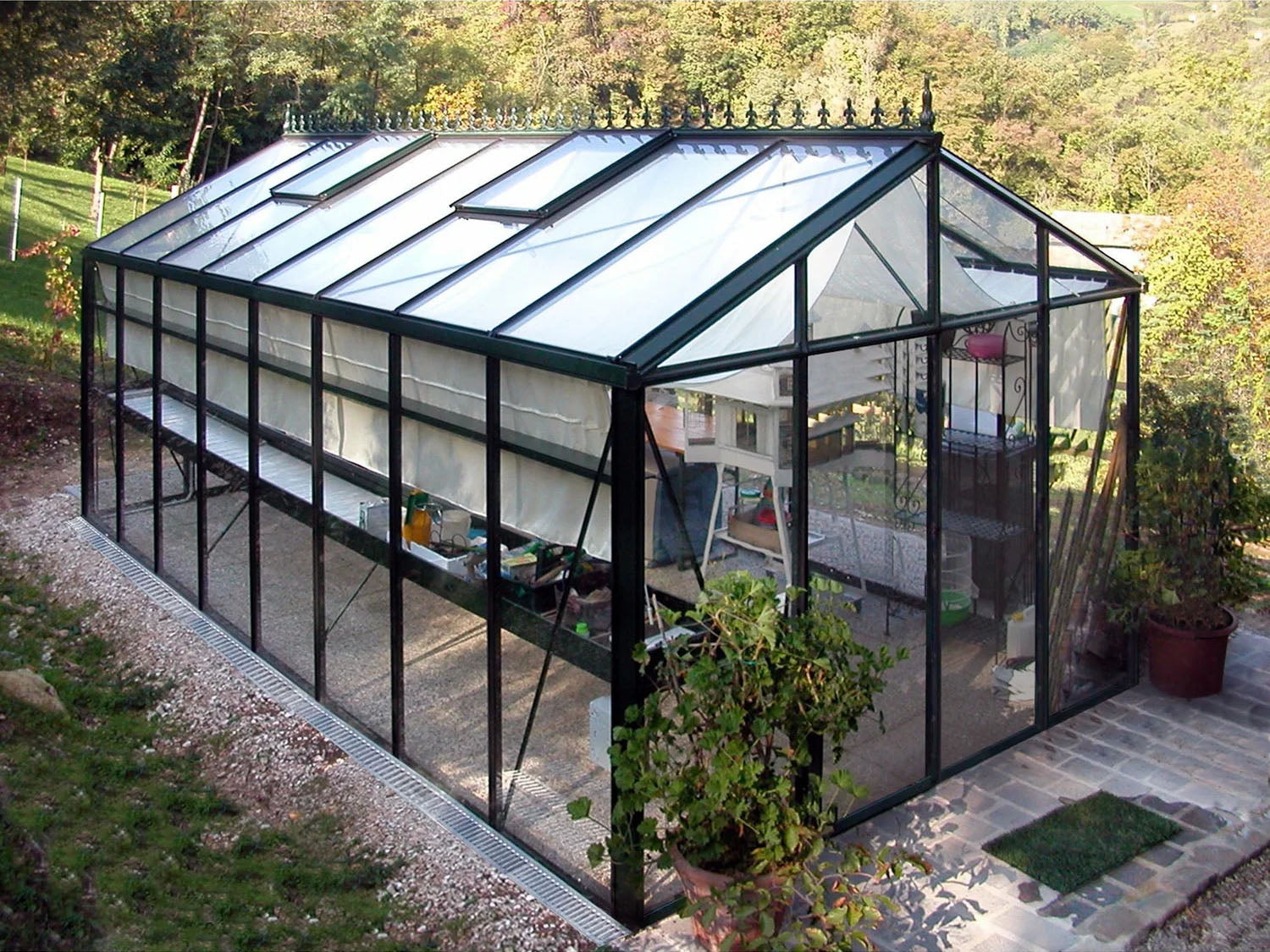 an actual image of the Exaco Janssens Royal Victorian Greenhouse VI 36 on a concrete base