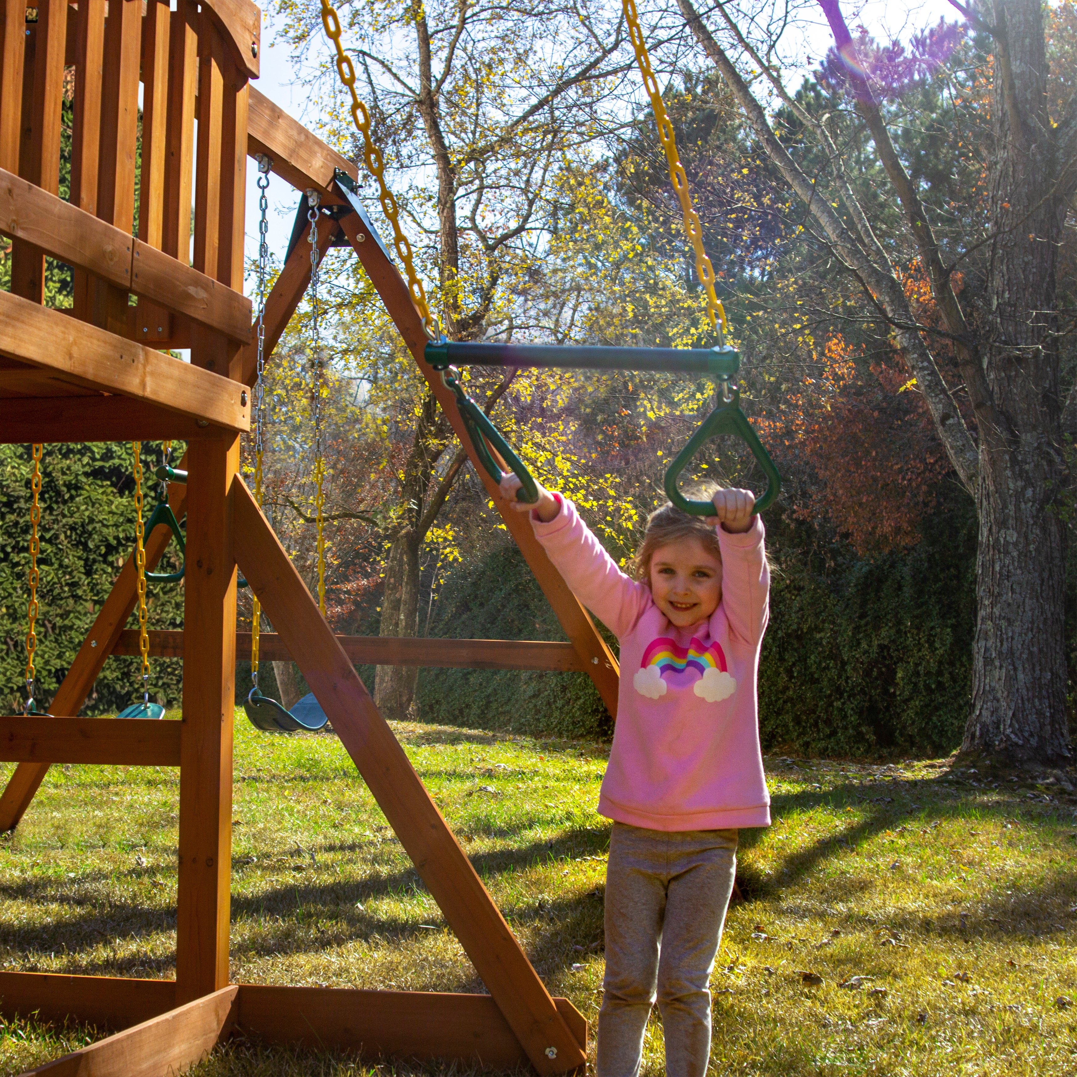 A child on a Trapeze play of the Outing With Trapeze Bar Swing Set