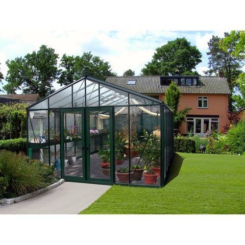 The Exaco Janssens Royal Victorian VI 46 Greenhouse in a residential setting with a lush lawn and neatly trimmed hedges, a perfect blend of functionality and home gardening.