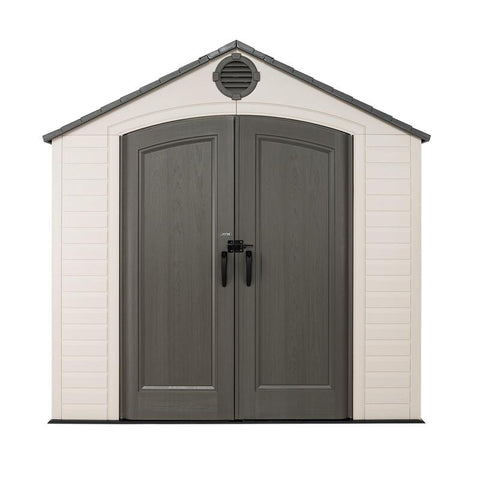 Front view of a Lifetime 8x15 ft outdoor storage shed featuring a gabled roof with an air vent and double doors with black handles.