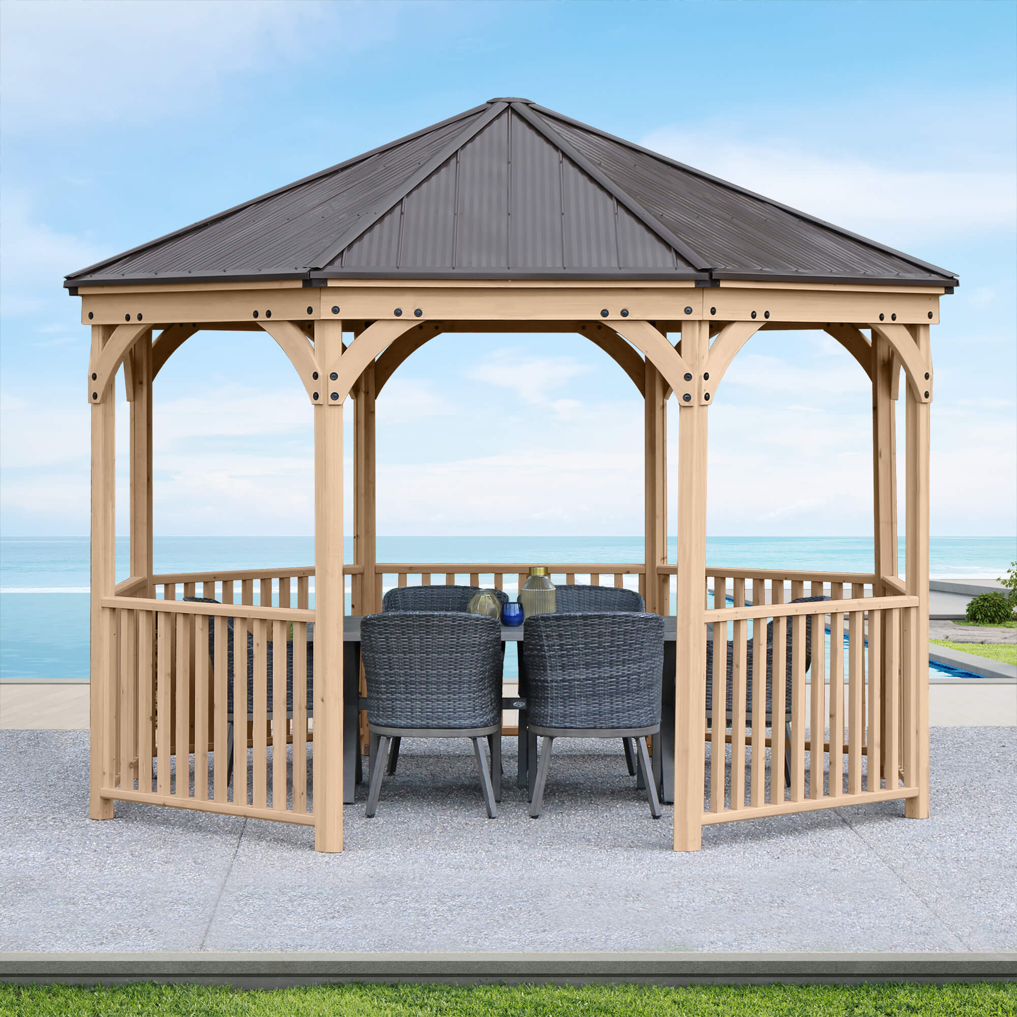 Fully assembled Yardistry 12 ft MOctagon Gazebo in a garden setting eridian with outdoor furniture under its shelter.